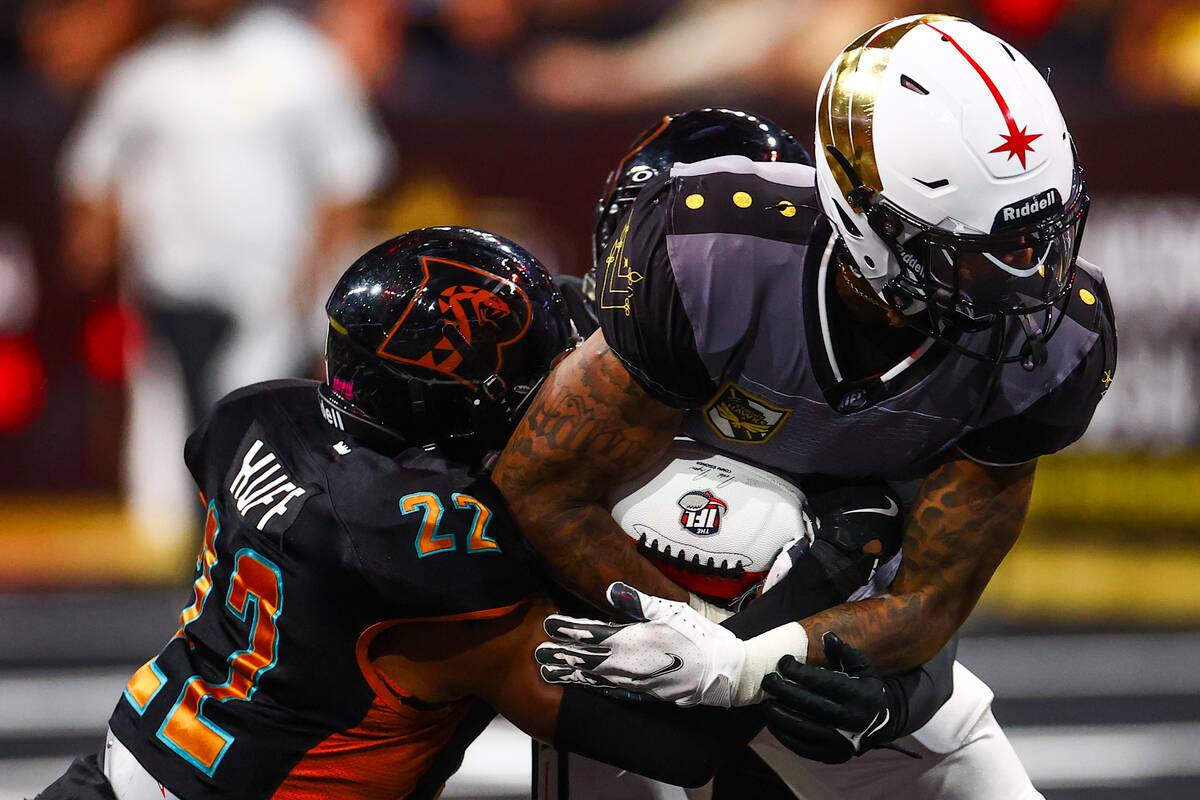 Vegas Knight Hawks wide receiver Caleb Holley (1) runs through a tackle by Arizona Rattlers def ...