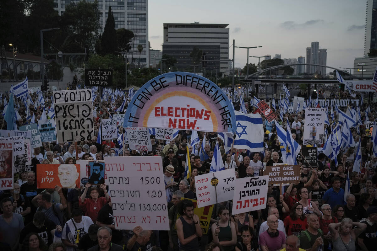 People attend a protest against Israeli Prime Minister Benjamin Netanyahu's government and dema ...
