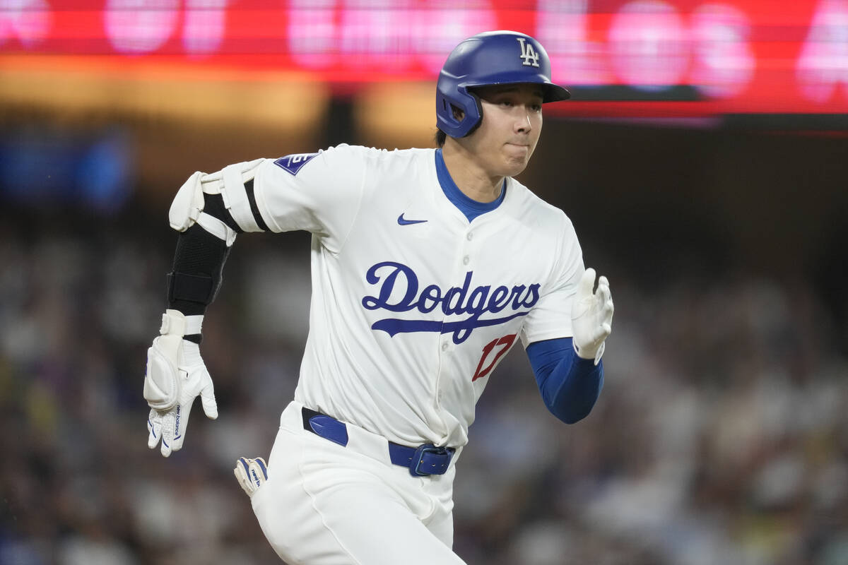 Los Angeles Dodgers designated hitter Shohei Ohtani singles during the eighth inning of a baseb ...