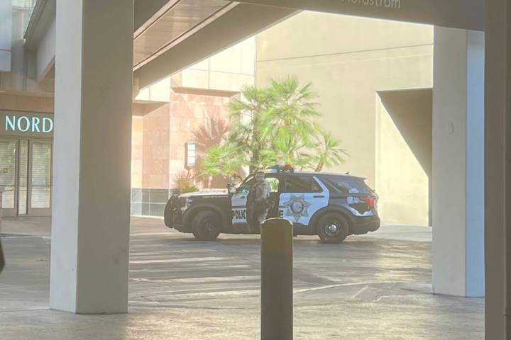 A Las Vegas police officer exits his SUV near the Nordstrom's entrance of the Fashion Show Mall ...