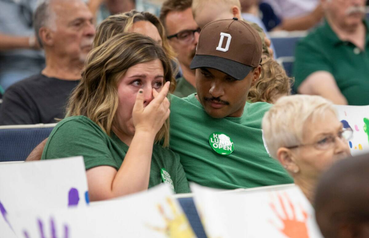 Taylor Plantin, left, an alum of Lundy Elementary School, is consoled by her husband Michael, r ...