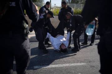 FILE - Israeli police officers remove an ultra-Orthodox Jewish man from the street during a pro ...
