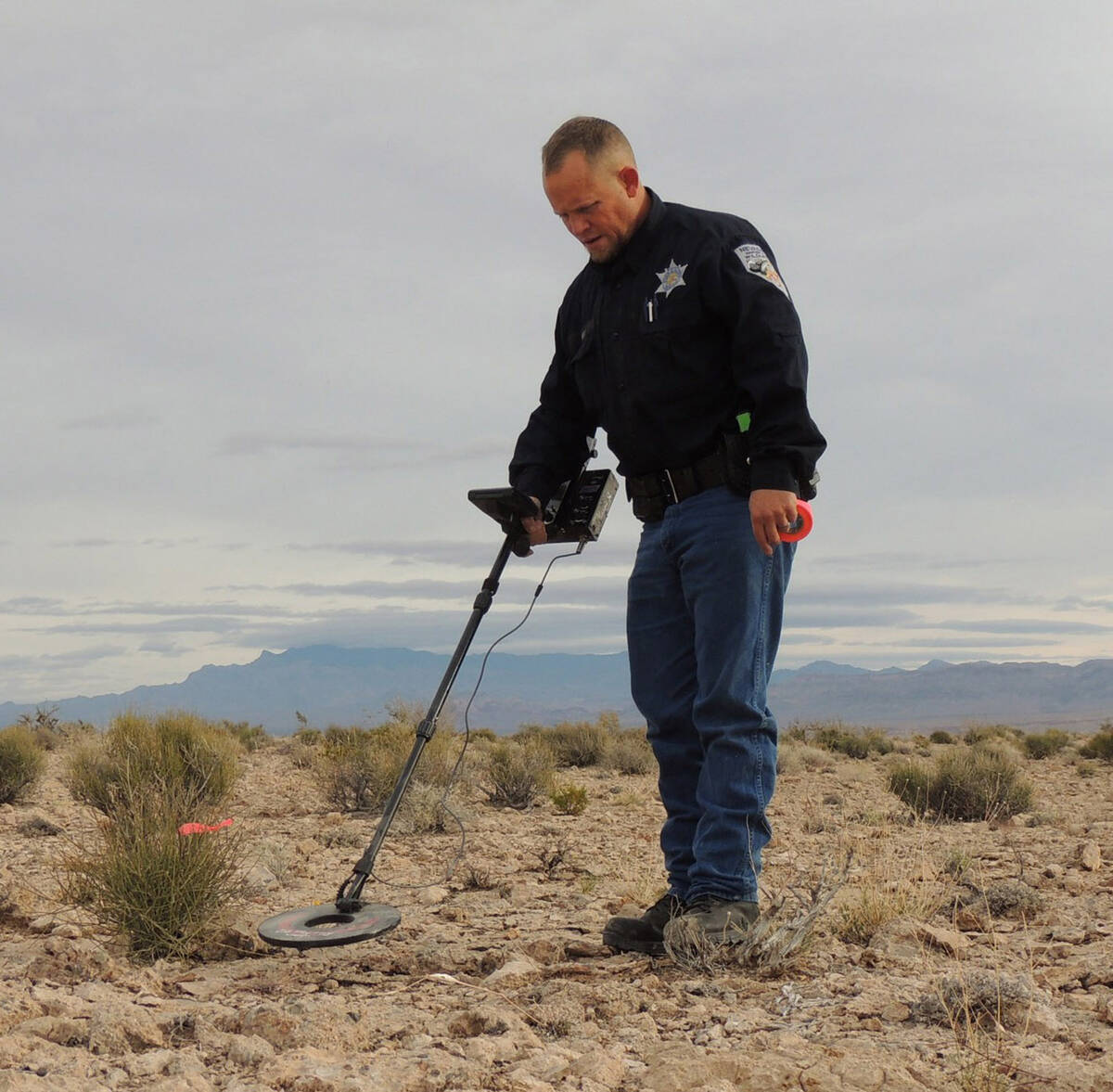 Game Warden Michael Geist looks for evidence using a metal detector near a poaching site in Sou ...