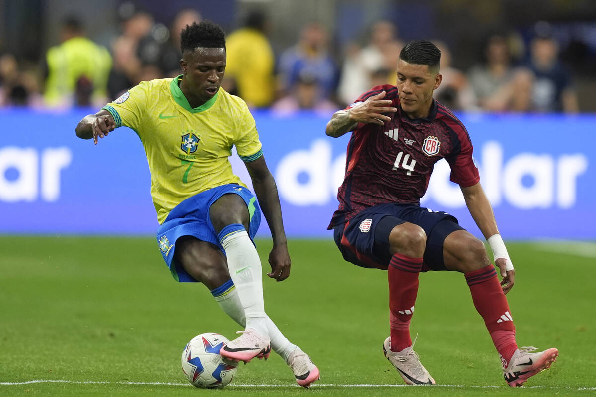 Brazil's Vinicius Junior, left, and Costa Rica's Orlando Galo battle for the ball during a Copa ...