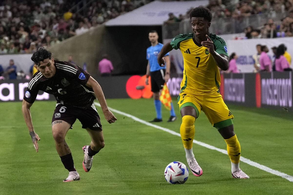 Jamaica's Demarai Gray (7) advances the ball as Mexico's Gerardo Arteaga (6) defends during a C ...