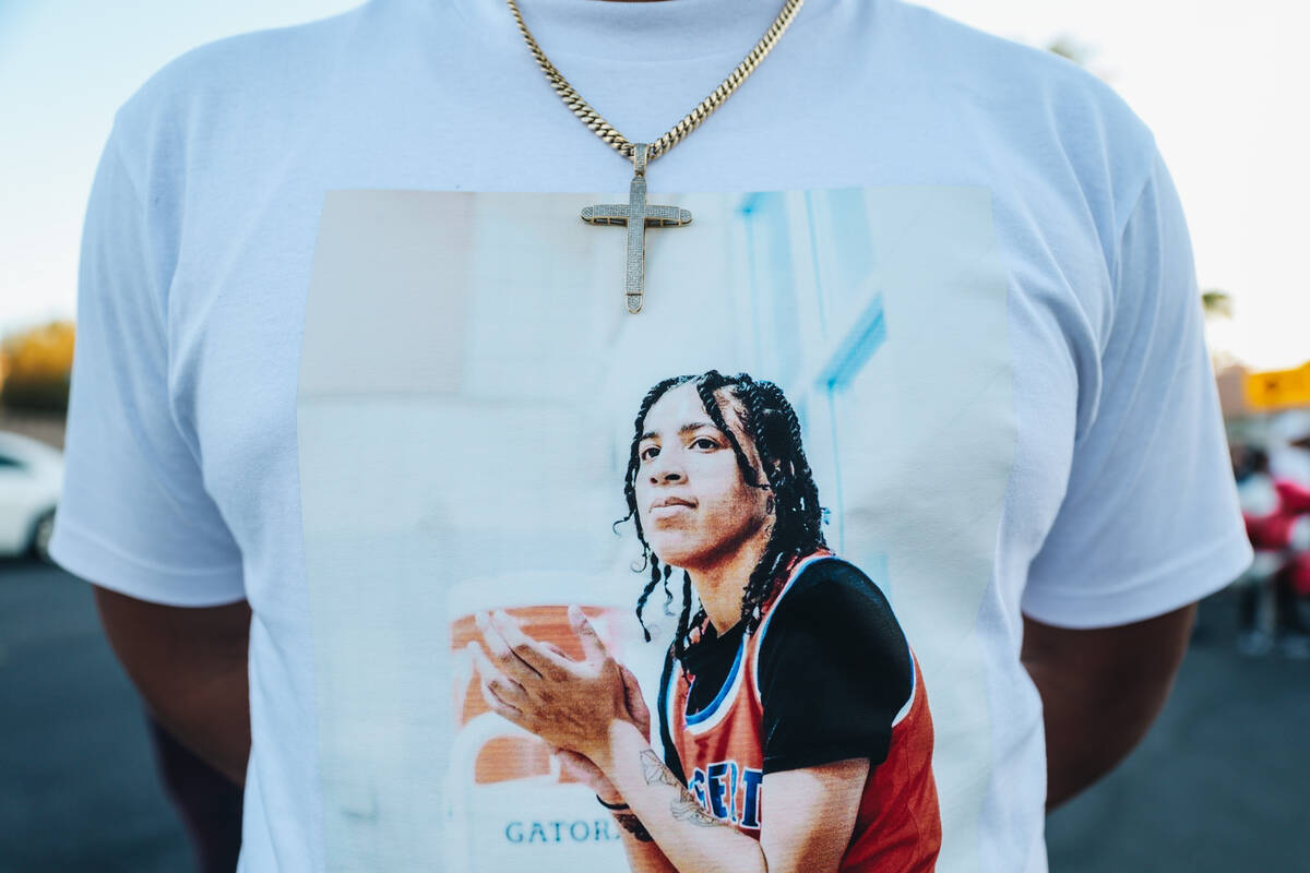 A mourner shows off a shirt with Kayla Harris on it during a vigil for Kayla Harris, who was ki ...