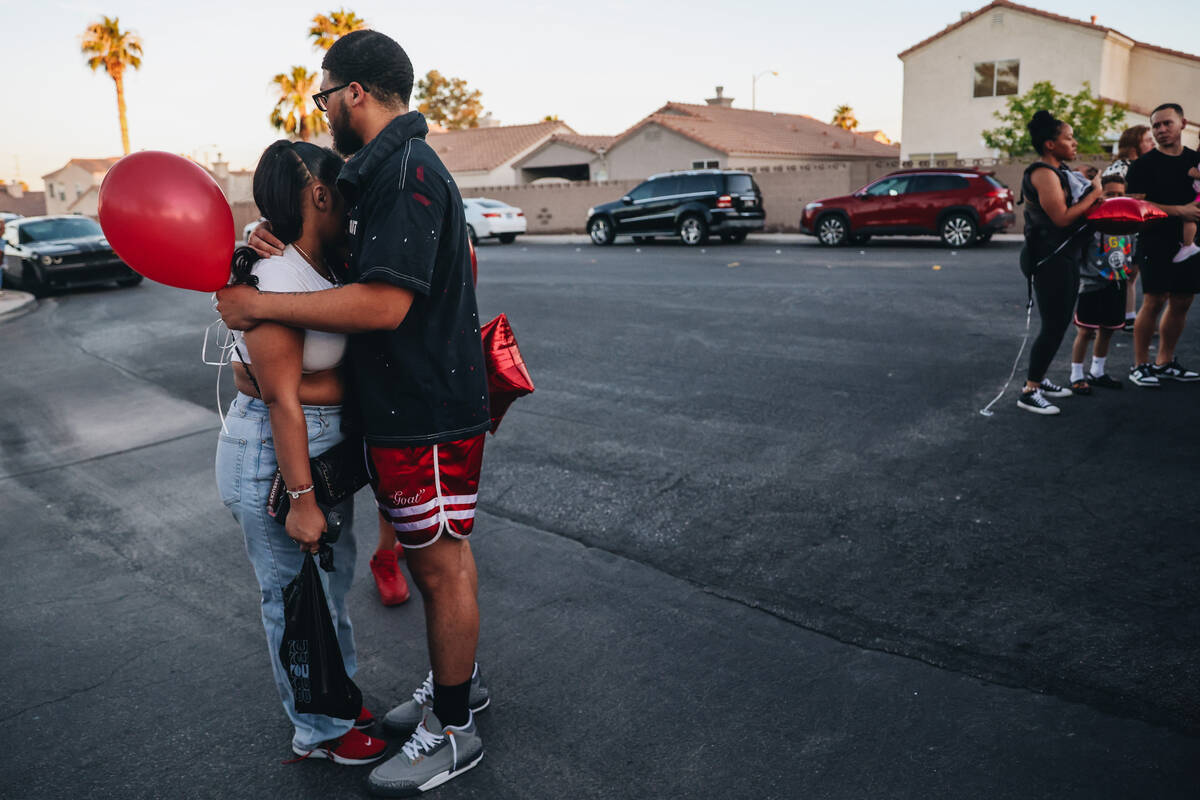 Jalen Simmons, Kayla Harris’ older brother, hugs a mourner during a vigil for Kayla Harris, w ...