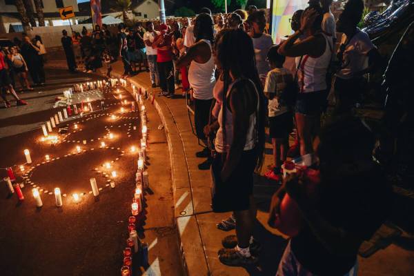 Candles are lit on the street during a vigil for Kayla Harris, who was killed in a quintuple ho ...