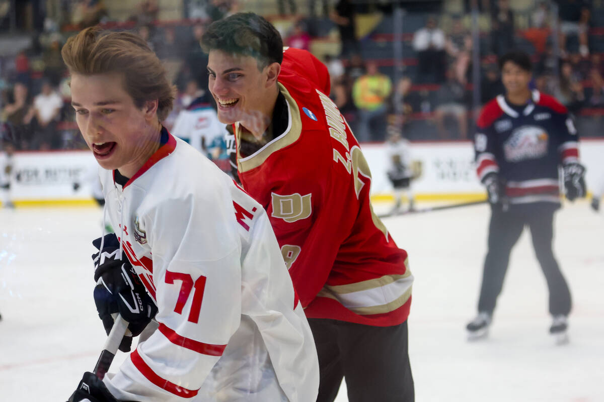 Top potential NHL Draft picks Macklin Celebrini, left, and Zeev Buium skate for the puck during ...