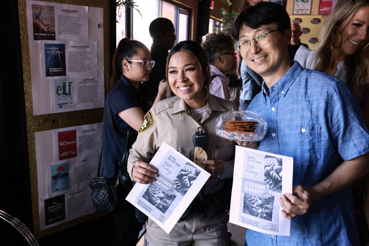 Las Vegas police officer Celina Cruz visits with Chang Kwon of Crown Bakery during the inaugura ...