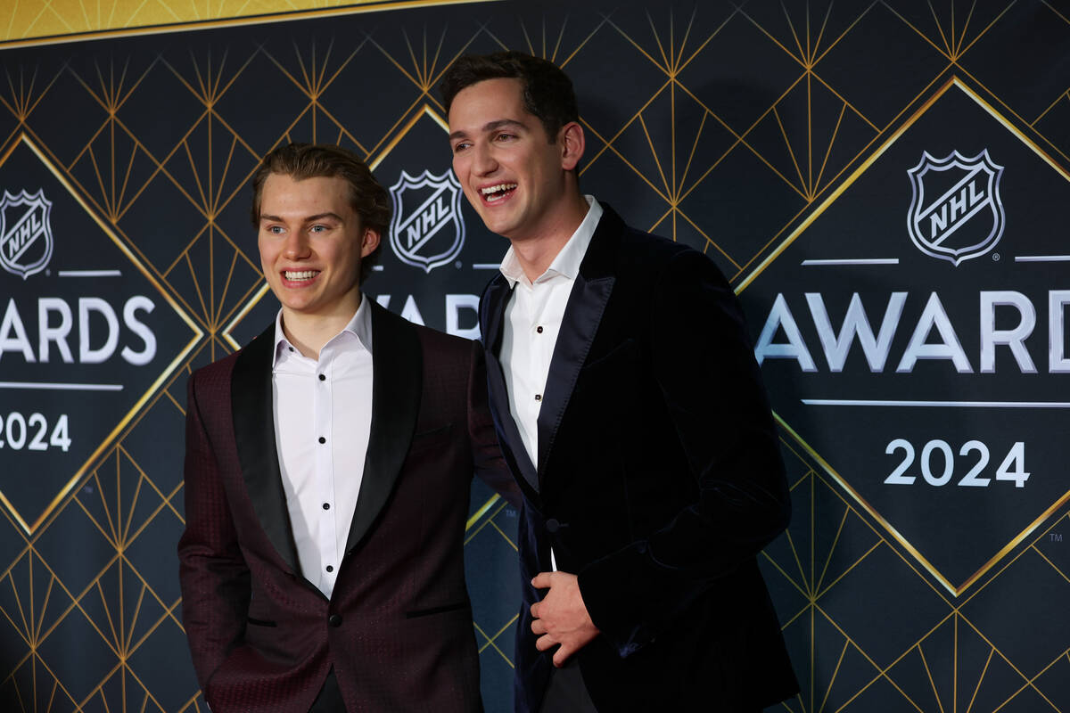 Blackhawks center Connor Bedard, the 2023 No. 1 draft selection, left, poses next to Comedian M ...