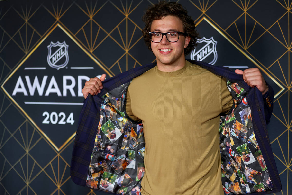 Minnesota Wild defenseman Brock Faber shows off the lining of his hack on the red carpet before ...