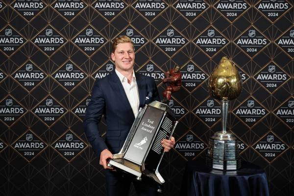 Colorado Avalanche center Nathan MacKinnon poses with the Ted Lindsay Award and the Hart Memori ...