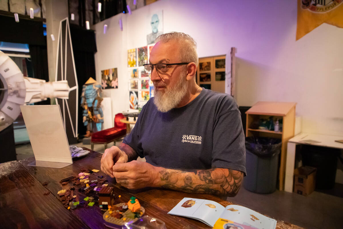 Steve Stephens works on a lego build at the Millenium Fandom Bar “Bricks n’ Booze ...