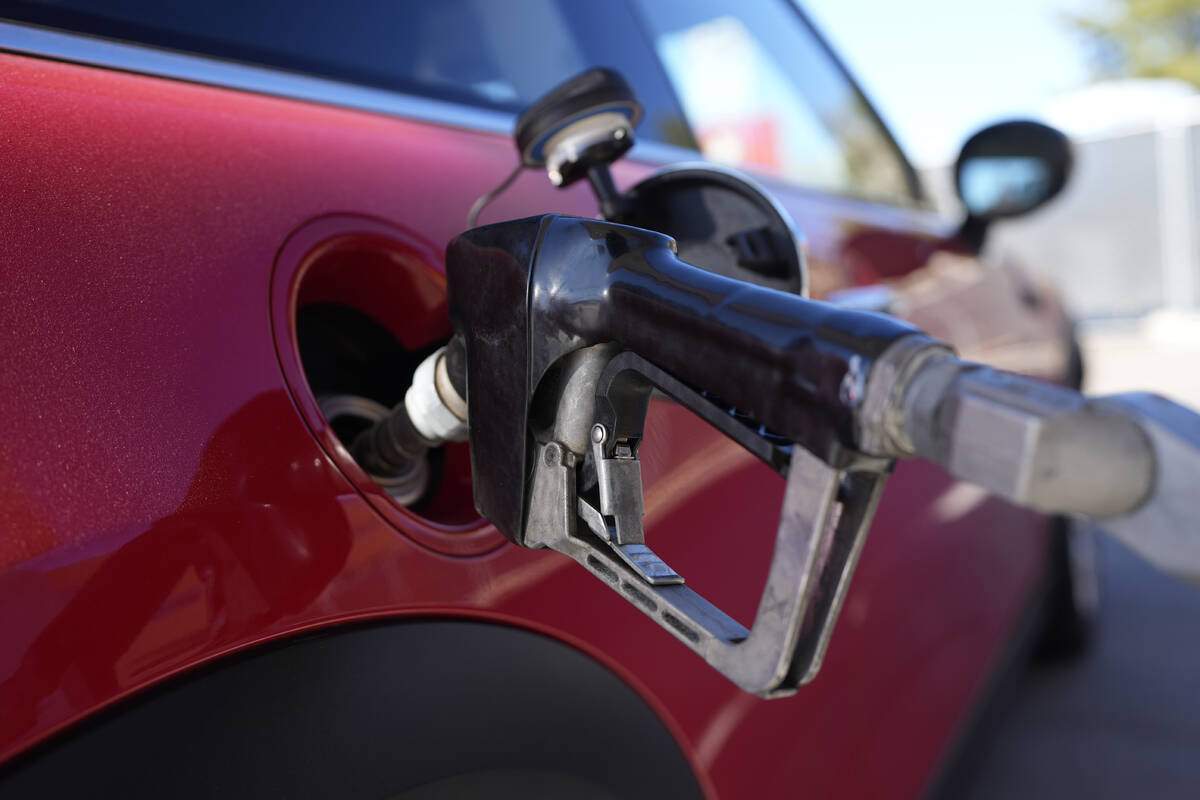 A motorist fills up the fuel tank of a vehicle at a Shell station Friday, Nov. 17, 2023, in Eng ...