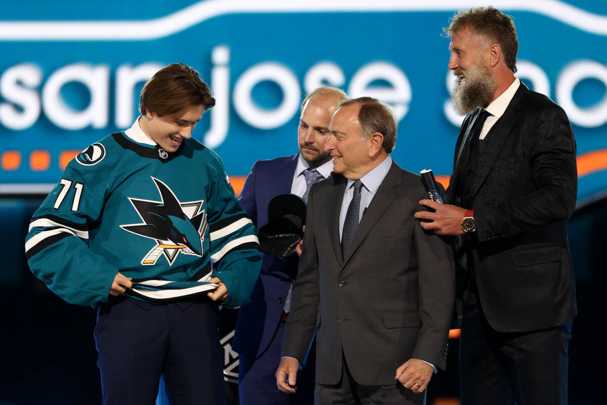 Center Macklin Celebrini puts on his jersey after the San Jose Sharks selected him first overal ...
