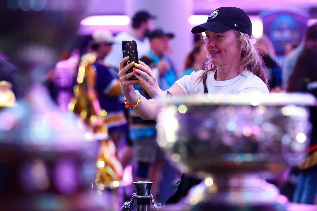 A fan photographs historic hockey trophies during the NHL hockey draft at Sphere on Saturday, J ...