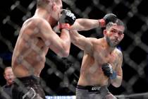 Mirsad Bektic, left, defends the punch by Dan Ige during the third round of a featherweight mix ...