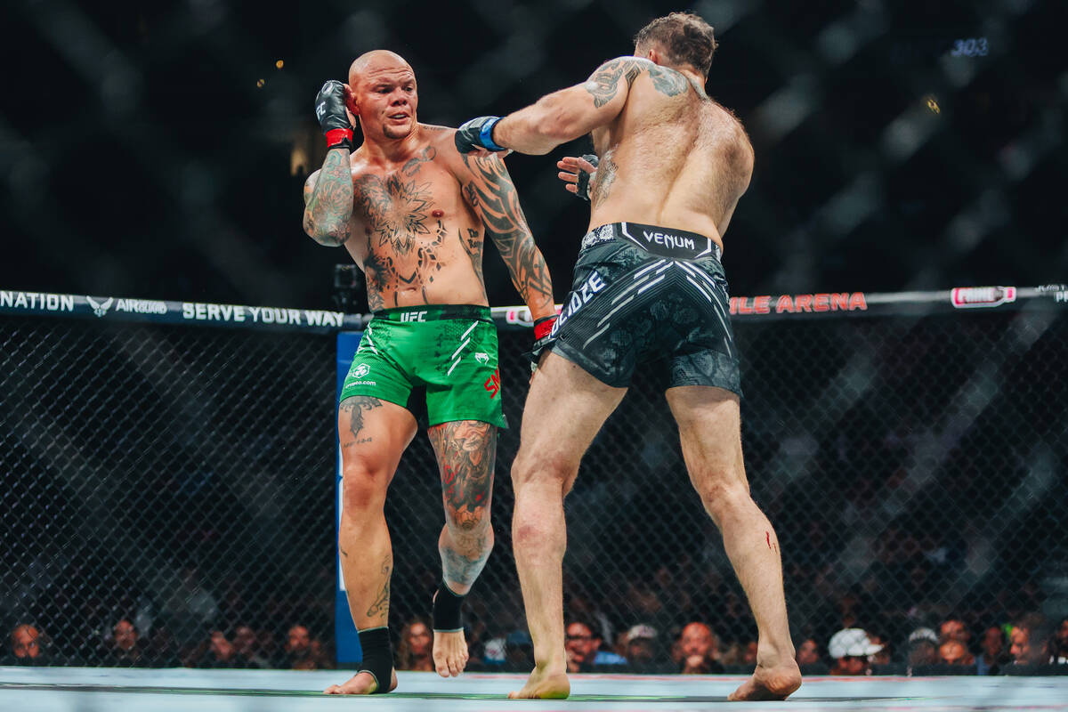 Anthony Smith, left, fights Roman Dolidze during their light heavyweight bout at UFC 303 at T-M ...