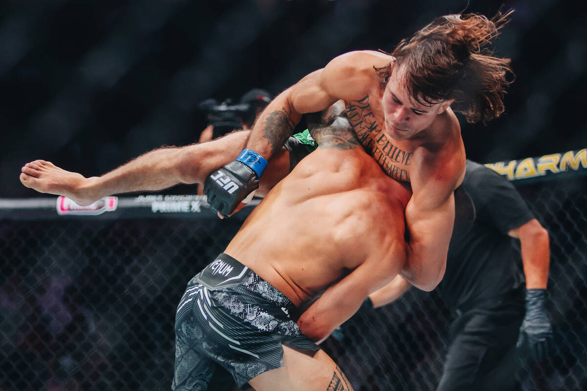 Dan Ige throws Diego Lopes onto the mat during their catchweight bout at UFC 303 at T-Mobile Ar ...