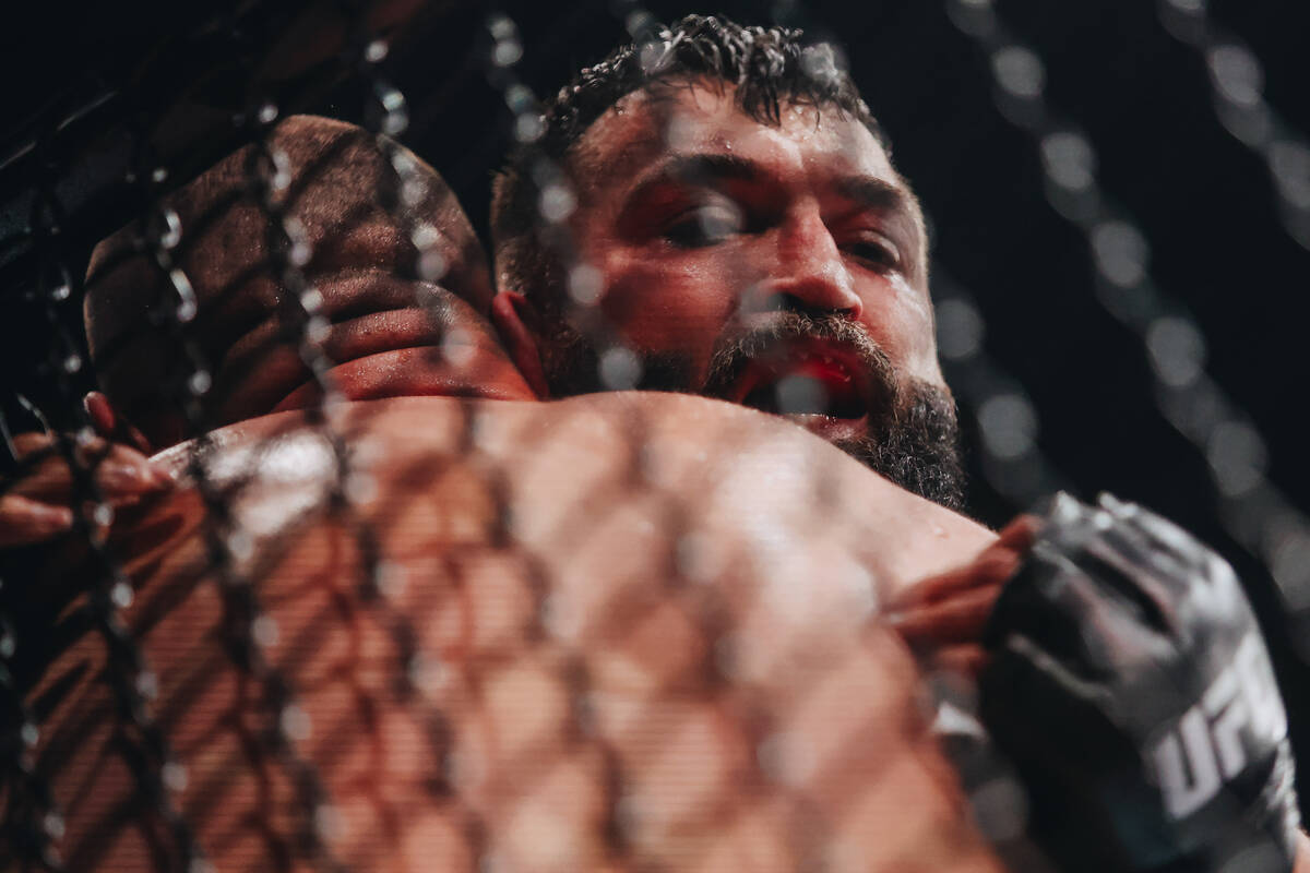 Andrei Arlovski pins Martin Buday against the cage during their heavyweight bout at UFC 303 at ...