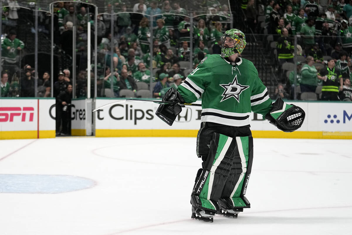 Dallas Stars goaltender Scott Wedgewood looks to the crowd, as spectators throw things onto the ...