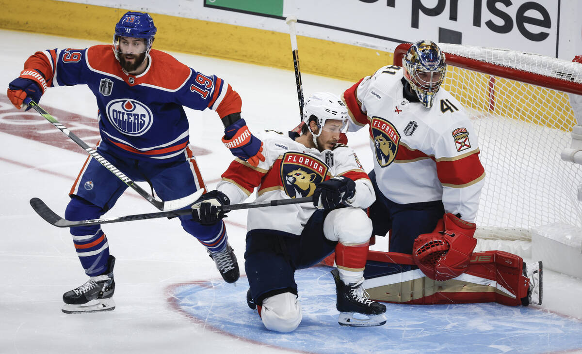 Florida Panthers' Brandon Montour (62) is pushed down by Edmonton Oilers' Adam Henrique (19) in ...