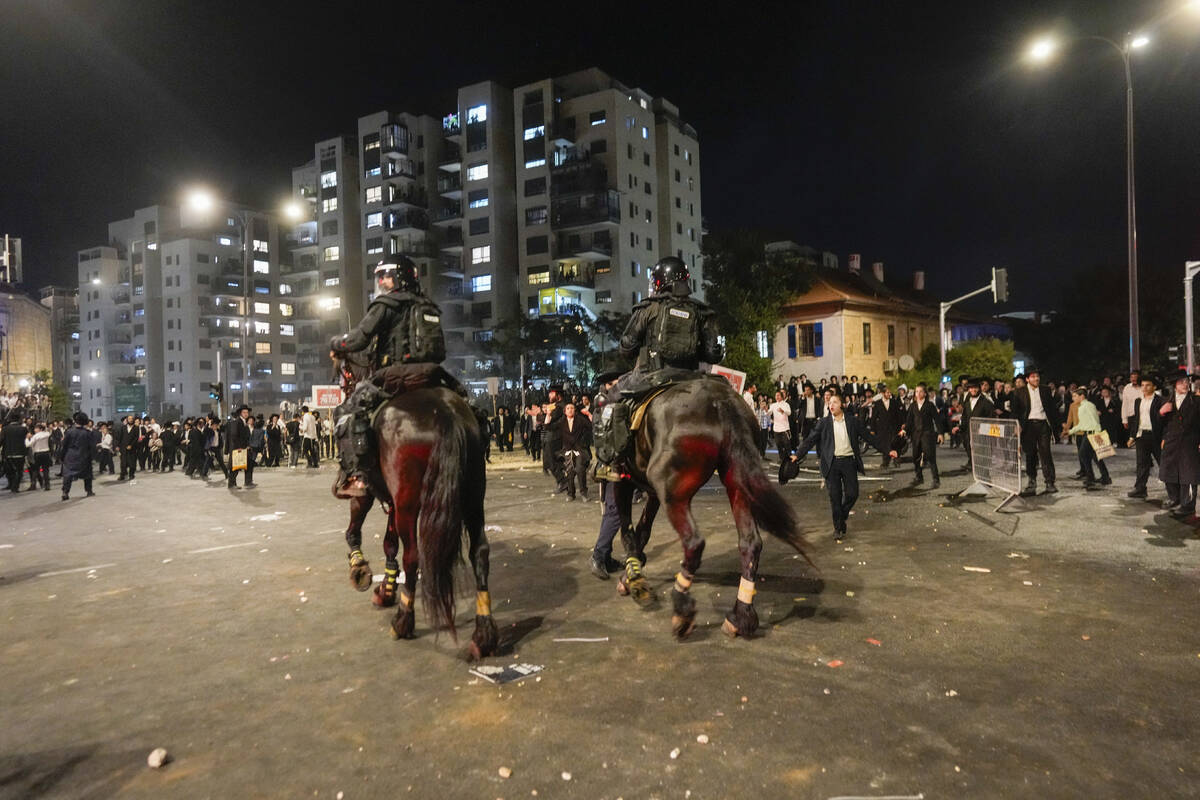 Ultra-Orthodox Jewish men clash with police during a protest against army recruitment in Jerusa ...