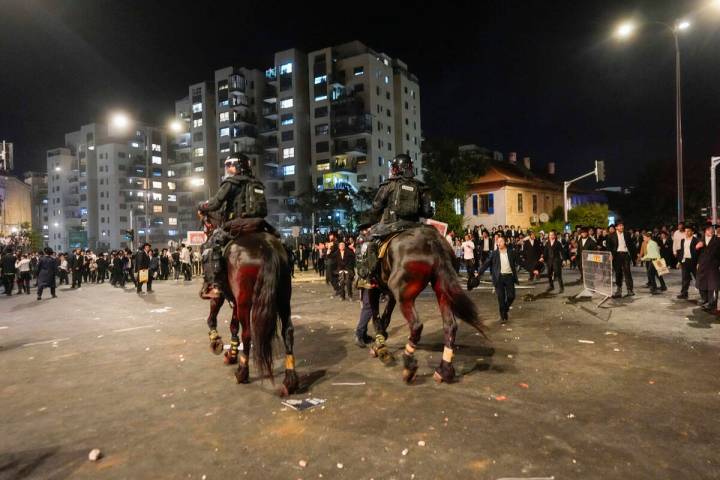 Ultra-Orthodox Jewish men clash with police during a protest against army recruitment in Jerusa ...