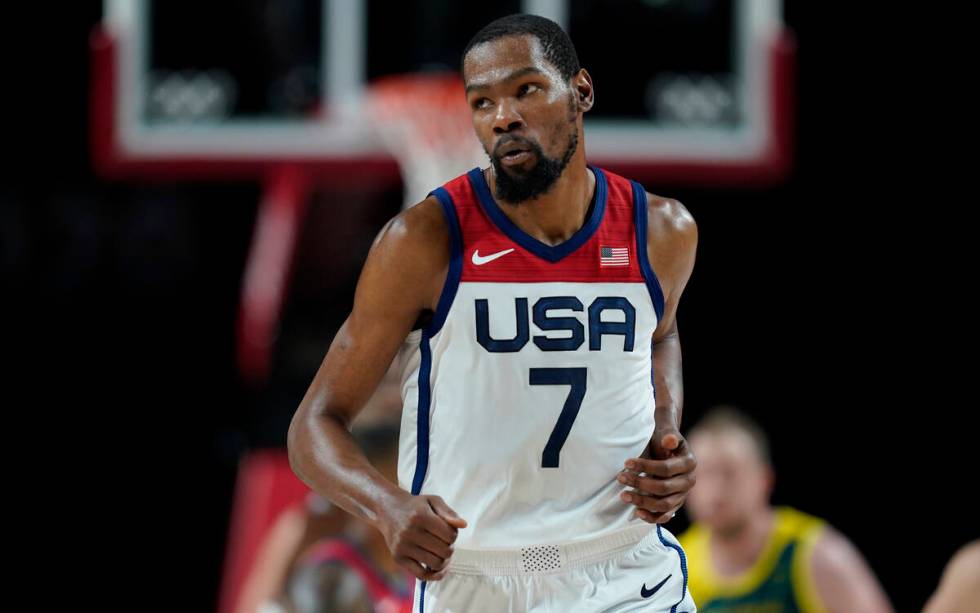 FILE - United States's Kevin Durant (7) runs up the court after making a three point basket dur ...