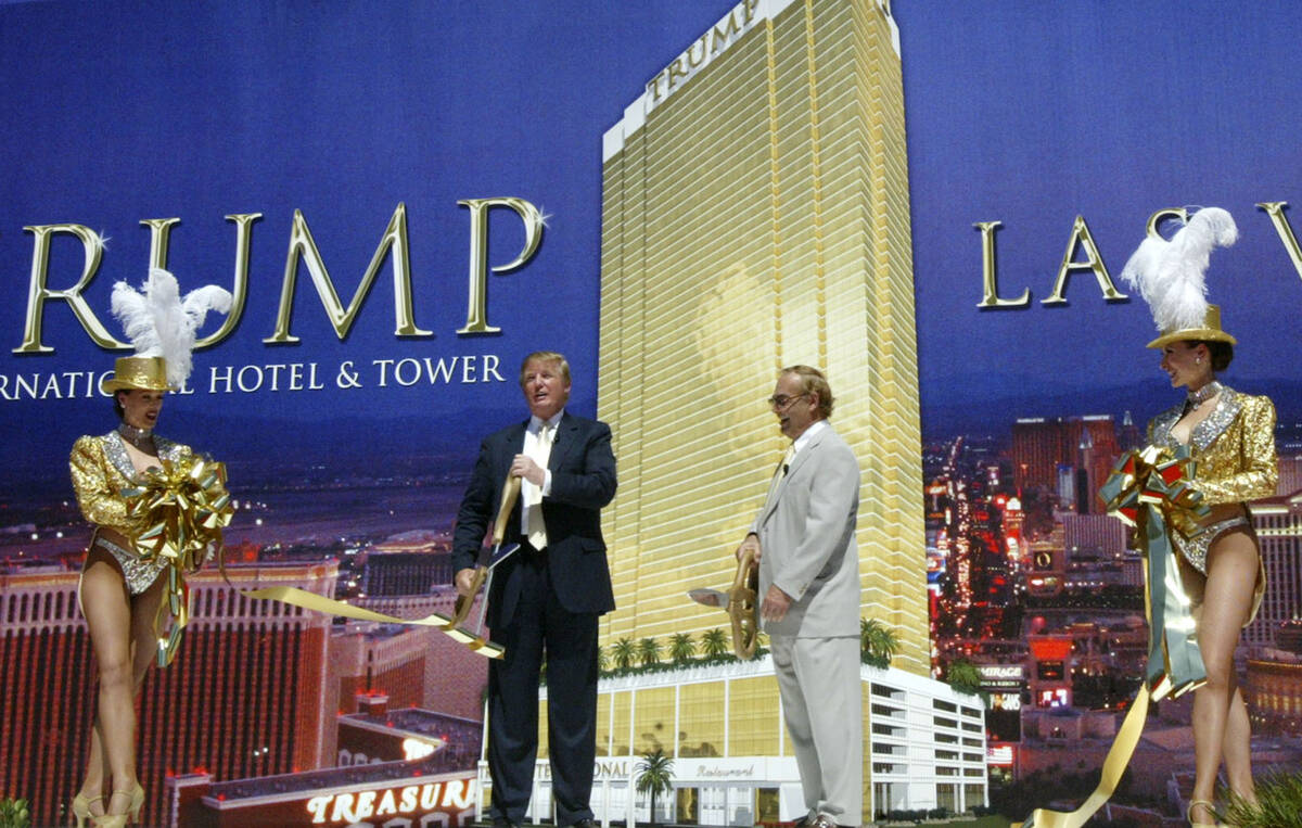 Donald Trump and business partner Phil Ruffin cut a ribbon with the help of two Las Vegas showg ...