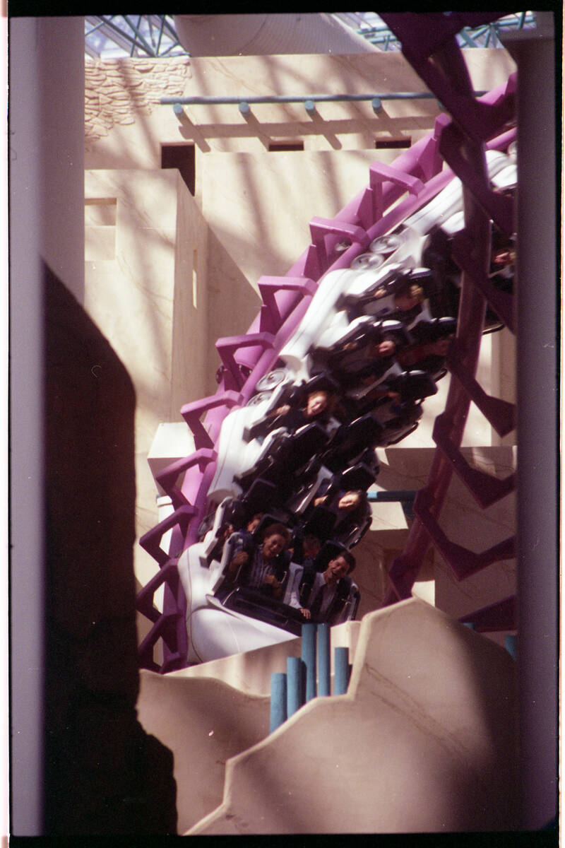 Guests ride the Canyon Blaster roller coaster inside the Adventuredome at Circus Circus on Aug. ...