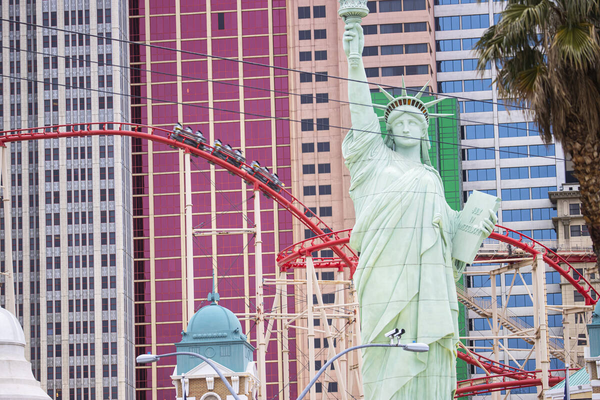 People ride on the Big Apple Coaster at New York-New York along the Las Vegas Strip on Thursday ...