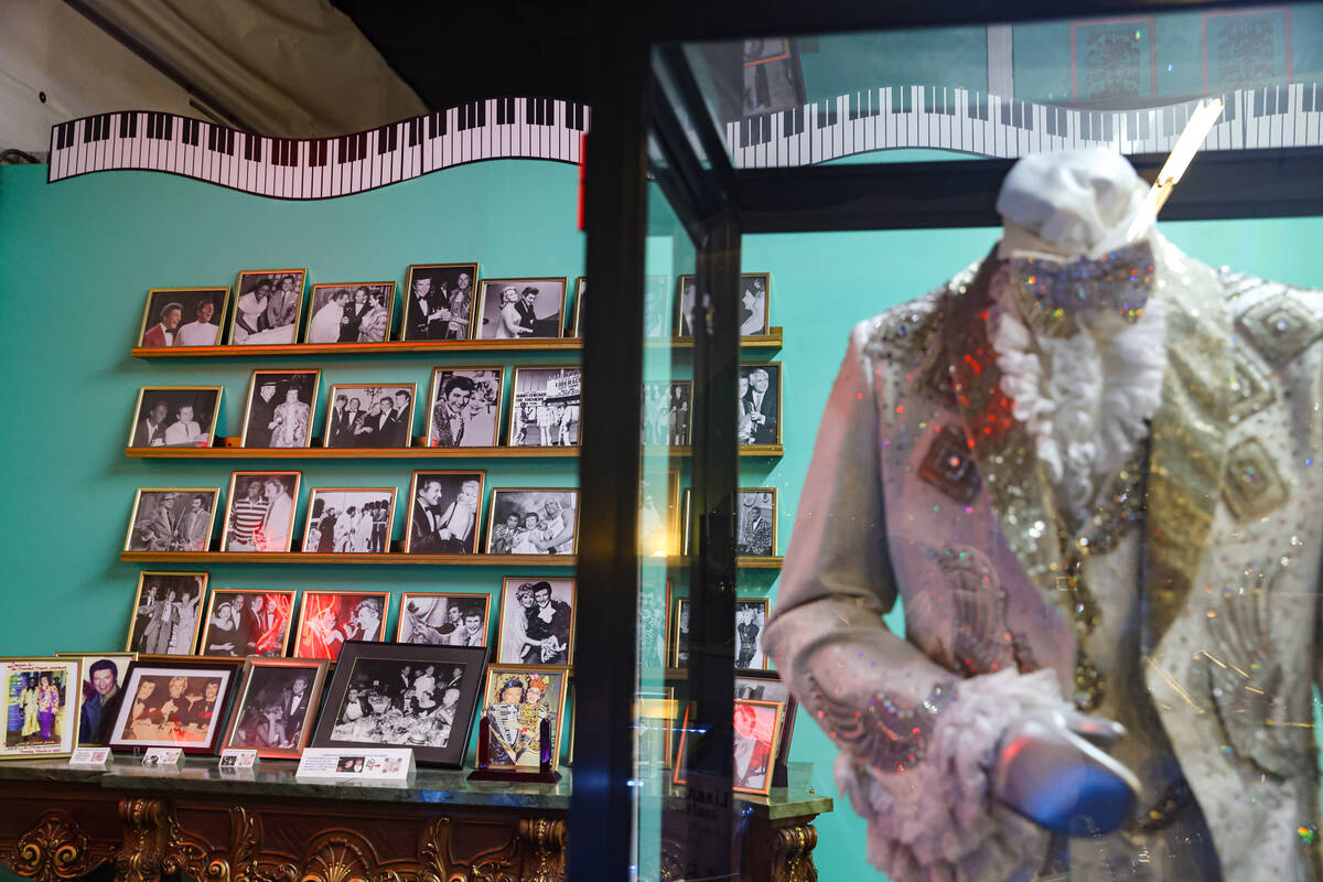 Photos of entertainer Liberace with various celebrities and a costume from the HBO movie Behind ...