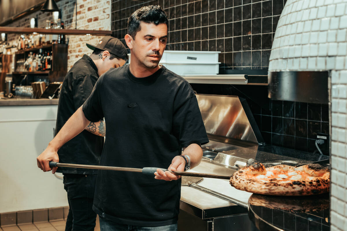 Pizzaiolo Michael Vakneen works the wood-fire oven at his Double Zero Pie & Pub, which is celeb ...