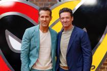 Ryan Reynolds, left, and Hugh Jackman pose for photographers upon arrival at the screening of t ...