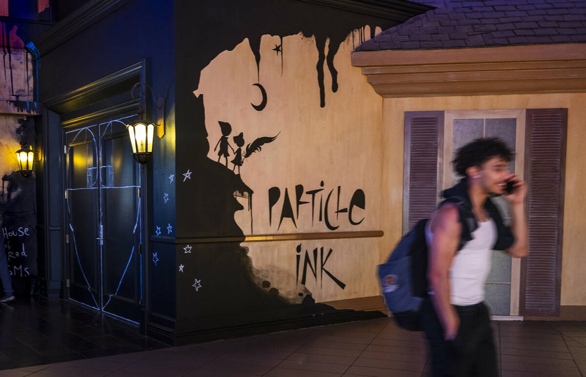 A person walks past the door for Particle Ink, an immersive attraction/performance show that op ...
