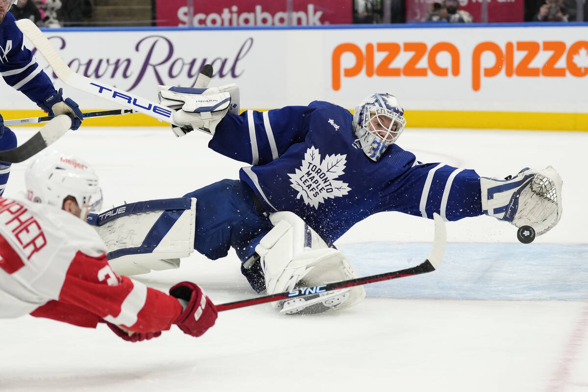 Toronto Maple Leafs goalie Ilya Samsonov, right, makes save against Detroit Red Wings J.T. Comp ...