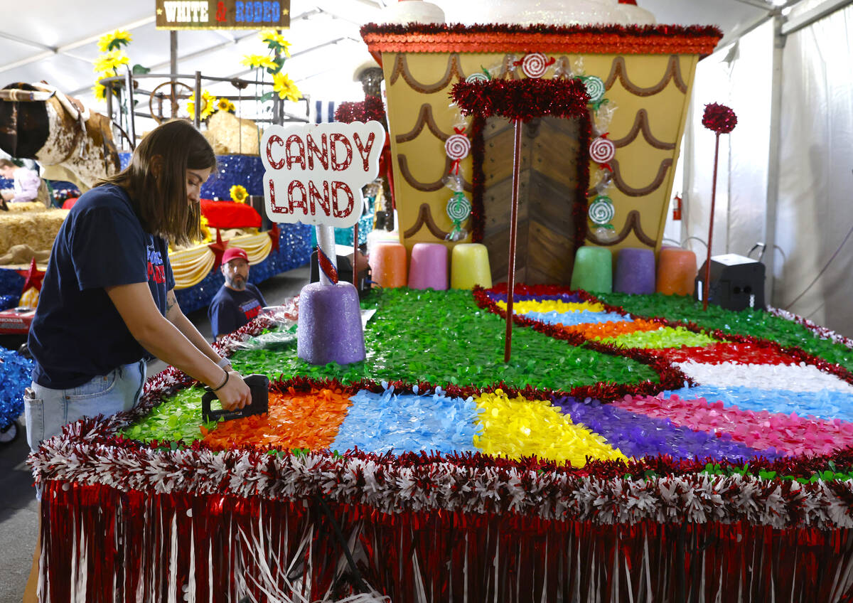 Jordyn Doyle, left, and Dave Bailey, both volunteers, decorate the “Visions of Candy Land” ...