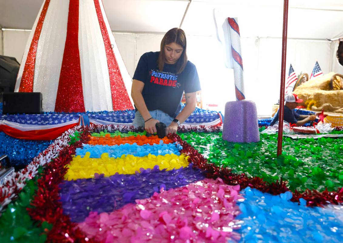 Jordyn Doyle, a volunteer, decorates the “Visions of Candy Land” float, to be featured in t ...