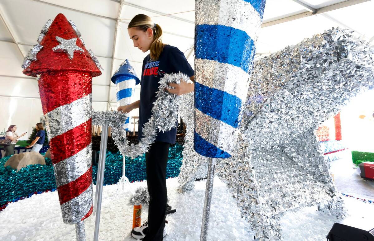 Kate Wagner, a volunteer, decorates “Donald's” float, to be featured in the Summerlin Patri ...