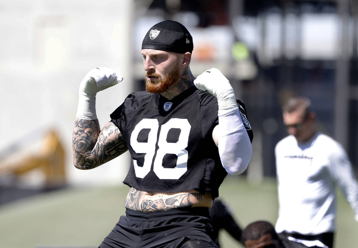 Raiders defensive end Maxx Crosby (98) stretches during an NFL football practice at the Intermo ...