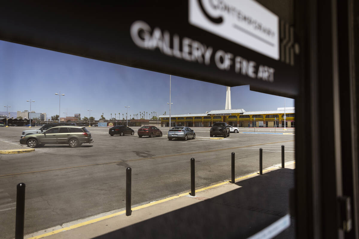 The parking lot of Commercial Center, one of the earliest major retail centers, is seen reflect ...