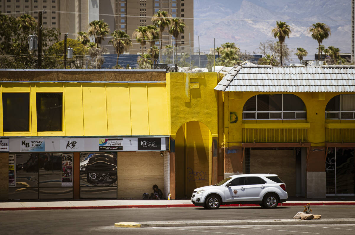 A Clark County vehicle passes a homeless individual in the shade at Commercial Center, one of t ...