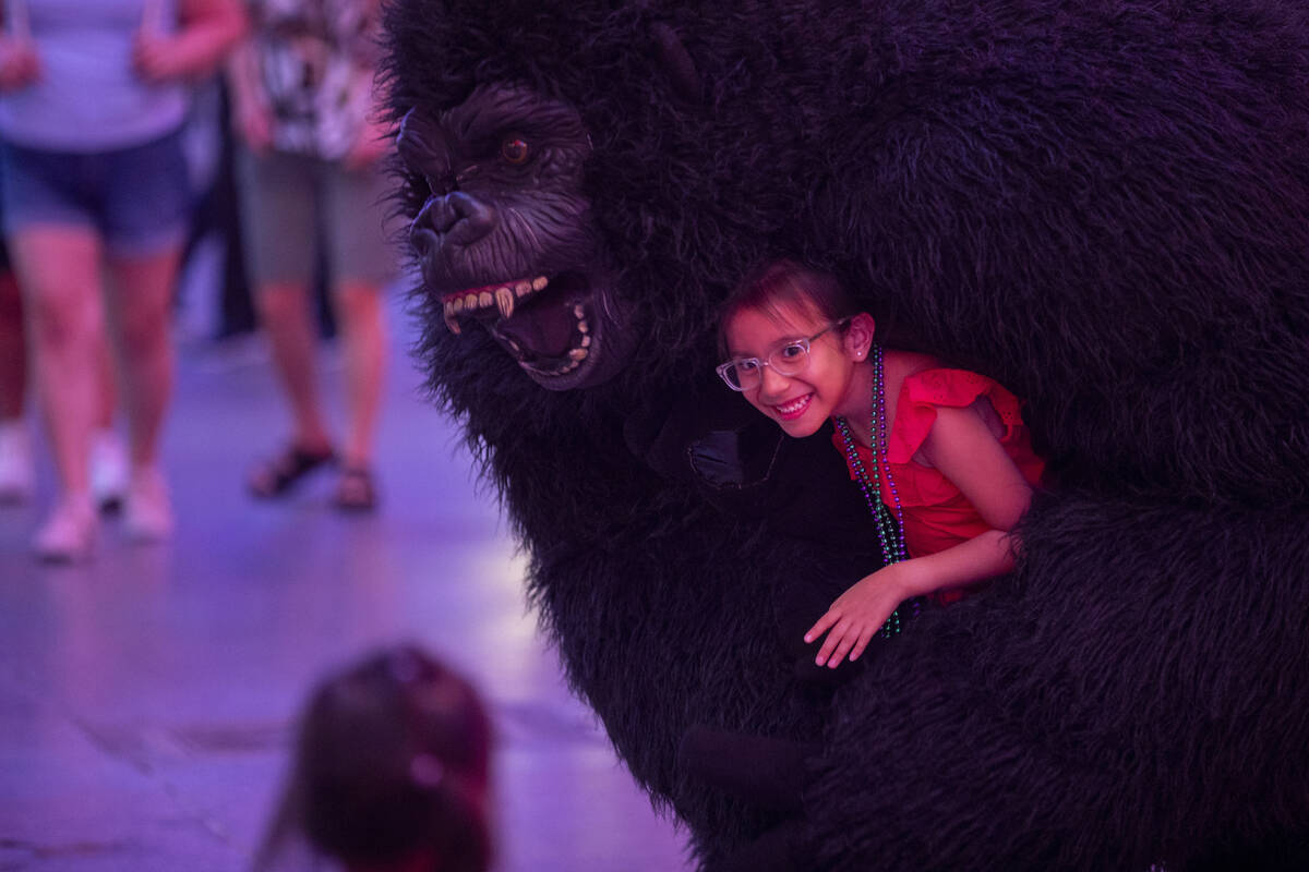 Tourists dance with a gorilla busker at the Fremont Street Experience Monday, July 1, 2024, in ...