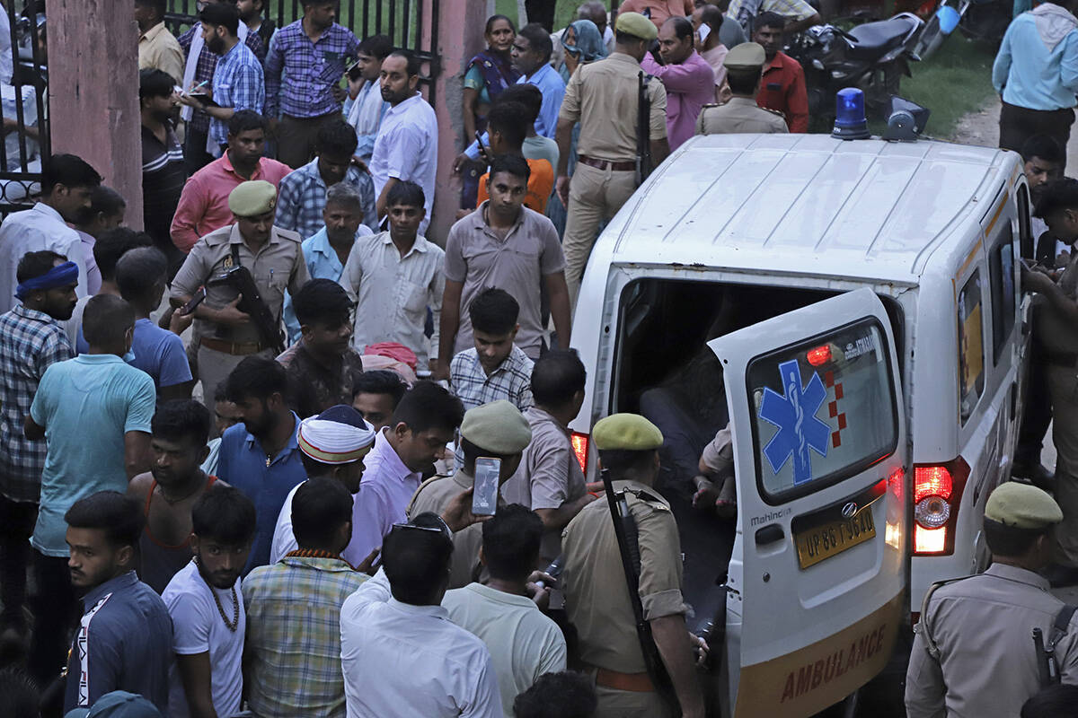 An injured arrives in an ambulance at the Sikandrarao hospital in Hathras district about 350 ki ...