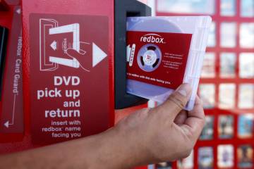 A rental DVD is dispensed from a Redbox at a 7-Eleven in Los Angeles on August 7, 2009. Chicken ...