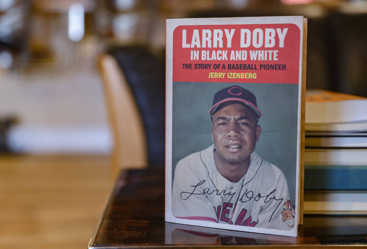 Hall of Fame sportswriter Jerry Izenberg’s book, Larry Doby in Black and White, at his home i ...