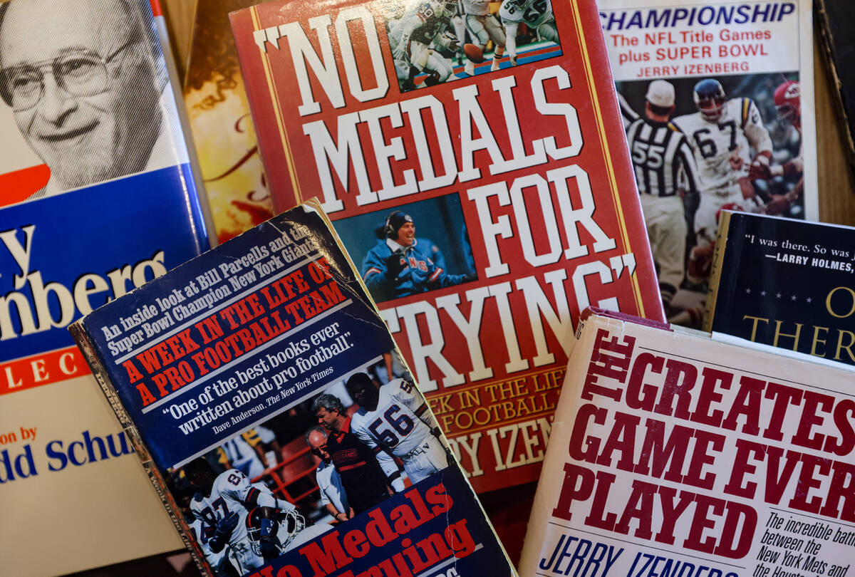 Books authored by Hall of Fame sportswriter Jerry Izenberg at his home in Henderson, Tuesday, J ...