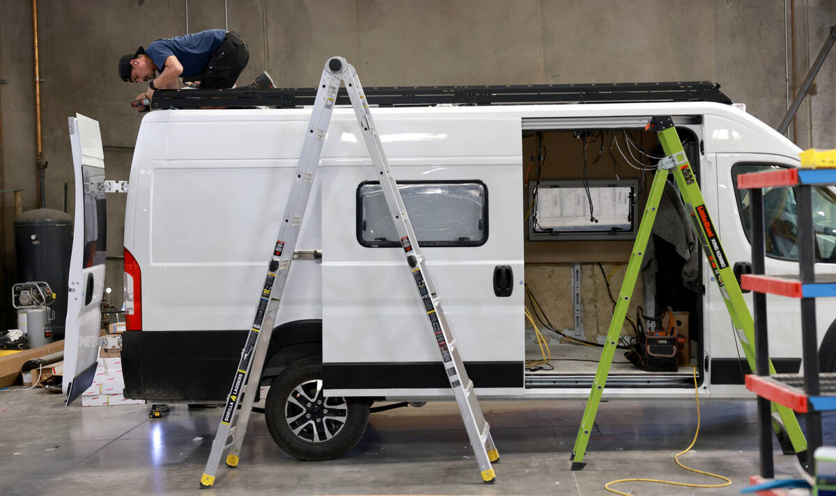 Workers convert a van into a motor home at Noovo manufacturing facility in Las Vegas Thursday, ...